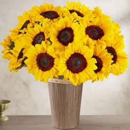 Bouquet of bright yellow sunflowers in a tall vase