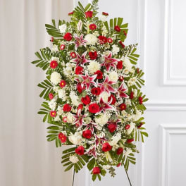 Standing floral spray with red and white flowers on an easel