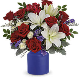 Red roses and white lilies arranged in a blue vase