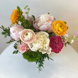 Mixed bouquet of pink, white, and yellow flowers