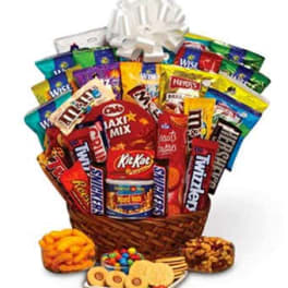 Basket of assorted candy and snack packs with a white bow