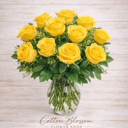Yellow roses arranged in a clear glass vase