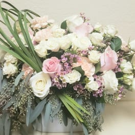 Bouquet of white and blush roses with small purple flowers