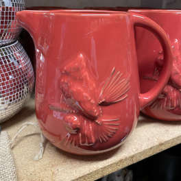 Red ceramic mug with an embossed fish design