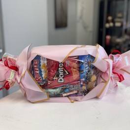 Candy bouquet wrapped in pink paper with ribbon bows
