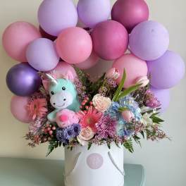 Balloon and flower arrangement with a plush unicorn in a white hatbox