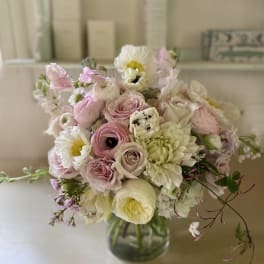 Soft pink and white bouquet in a glass vase