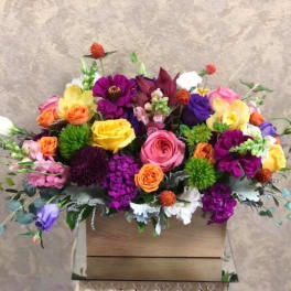 Colorful mixed flower arrangement in a wooden box