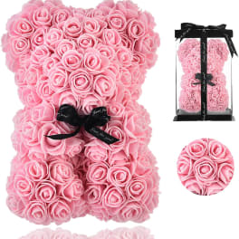 Pink rose teddy bear with a black ribbon bow in a clear box