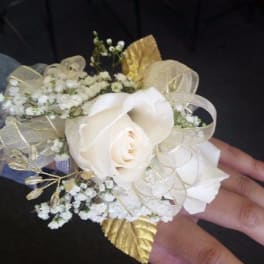 White rose wrist corsage with gold ribbon and baby's breath