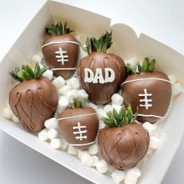 Box of chocolate-covered strawberries decorated like footballs and one with "DAD"