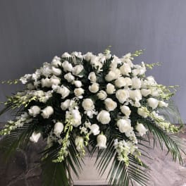 Large white floral arrangement in a white container