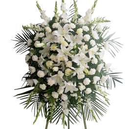White funeral spray with lilies, roses, and carnations on a standing easel