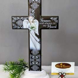 Decorative memorial cross with an angel and flowers on a pedestal base