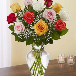 Bouquet of multicolored roses in a clear glass vase