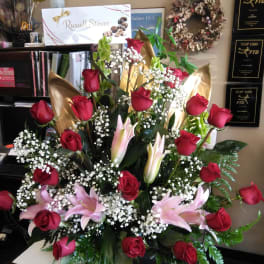 Large bouquet of red roses and pink lilies with baby's breath