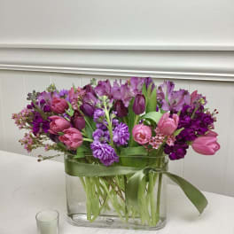 Pink and purple tulips with alstroemeria in a glass vase