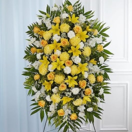 Large standing floral spray with yellow and white flowers on an easel