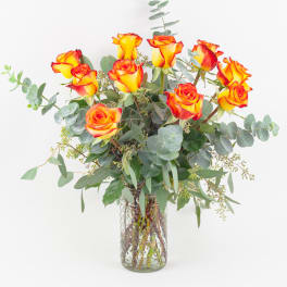 Bouquet of yellow-orange roses in a clear glass vase