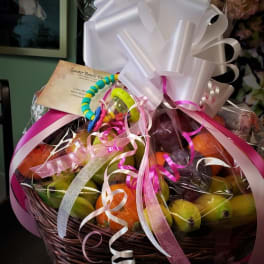 Fruit basket with colorful ribbon and a large white bow