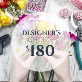 Hands holding a pastel bouquet with a $180 designer's choice label