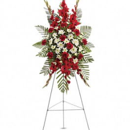 Standing floral spray with red and white flowers on an easel