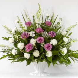 Pink roses and white carnations in a white vase