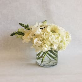 White floral arrangement in a clear glass vase