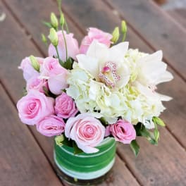 Pink roses and white hydrangeas in a green striped vase