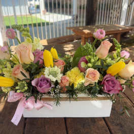Mixed bouquet of roses and yellow tulips in a white box