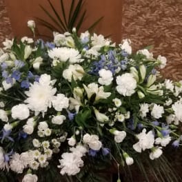 Large white and blue floral spray arranged on the floor