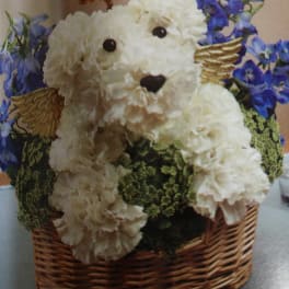 White flower teddy bear in a wicker basket with blue flowers