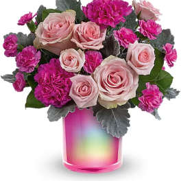 Pink roses and magenta carnations in a pink iridescent vase