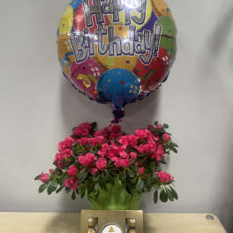 Birthday balloon above pink flowers and a Ferrero Rocher chocolate box