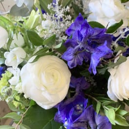 Bouquet of white and purple flowers with green foliage