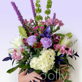 Large mixed bouquet in a purple vase with pink, white, and lavender flowers