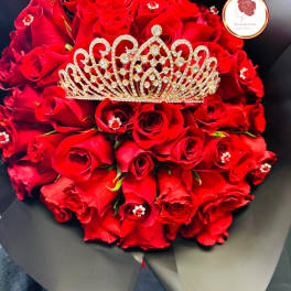 Bouquet of red roses with a jeweled tiara on top