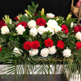 Red and white roses with carnations in a large floral arrangement