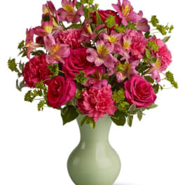 Pink and magenta bouquet in a pale green vase