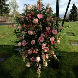 Tall pink floral standing spray with roses and daisies