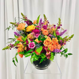 Colorful mixed flower arrangement in a black vase