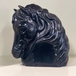 Black horse-shaped decorative object on a shelf