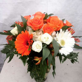 Bouquet of orange and white flowers in a glass vase