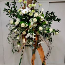 Tall floral arrangement with white roses and calla lilies on branches