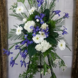 Standing floral spray with white daisies, hydrangeas, and purple irises