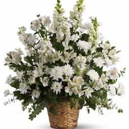 White floral arrangement in a woven basket