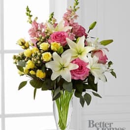 Pink and white floral bouquet in a clear glass vase