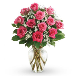 Pink roses arranged in a clear glass vase