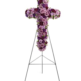 Purple floral cross on a metal stand