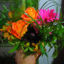 Bouquet of orange roses and pink gerbera daisies with greenery